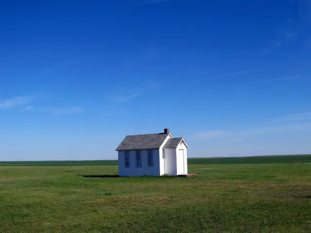 Small white replica church on the prairie (St. John's Lutheran, Mendham)