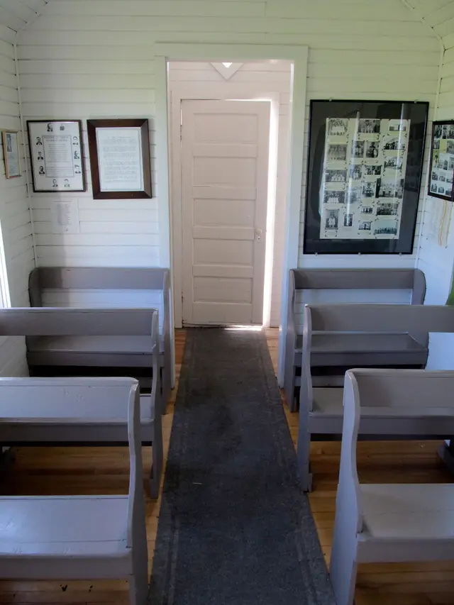 Inside a tiny church with pews